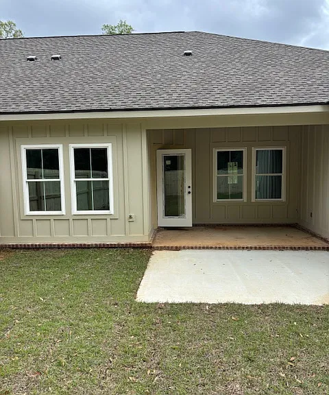 Back porch and patio space in a fenced in yard