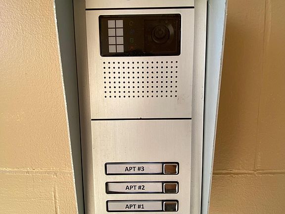 Security system with individual unit call buttons and voice verification.