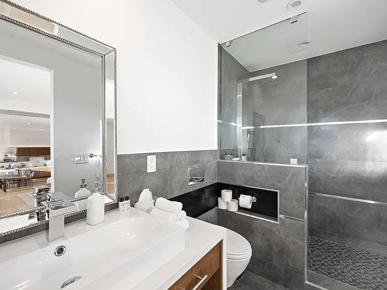 Rejuvenate in our lavish ensuite bathroom, featuring a spacious walk-in shower and designer fixtures.