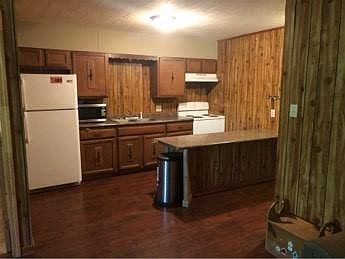 Kitchen includes fridge, stove and microwave.