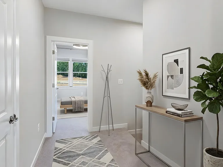 Bright upper-level hallway provides easy access to the bedrooms, bathrooms, and laundry area. Virtually staged.