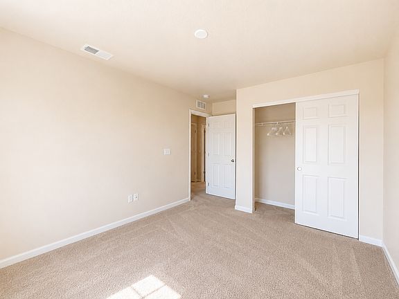 Room 2 showing the open closet, bedroom entrance and flexible wall space for arranging furniture. Room is rented unfurnished. Digitally enhanced for presentation.