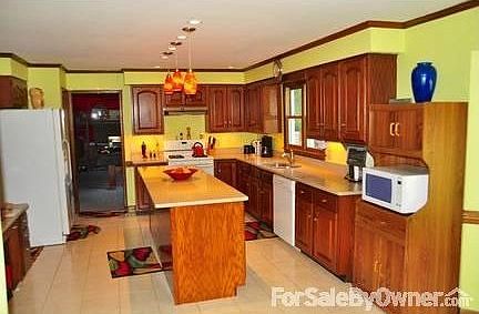 Huge island with wine refrigerator.