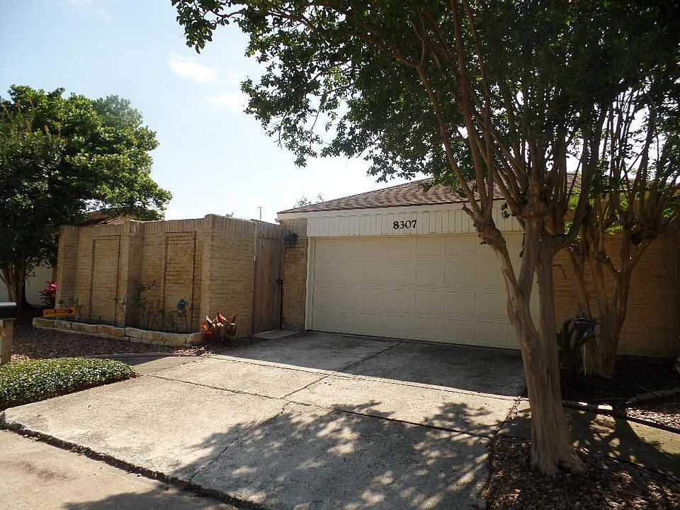 Private home is surrounded with brick walls in a quiet neighborhood