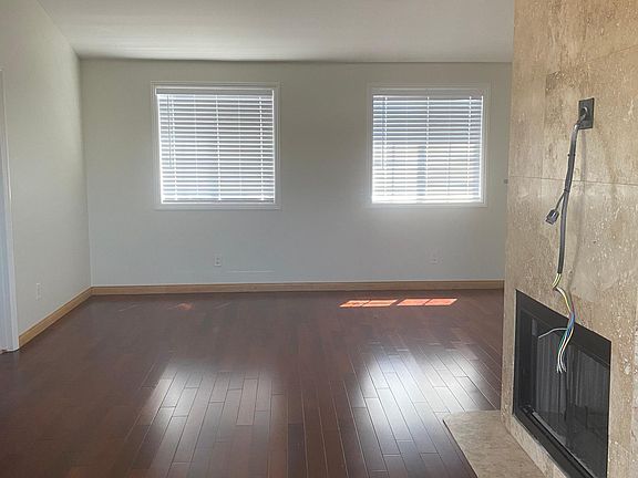 living room with gas fireplace and high ceilings