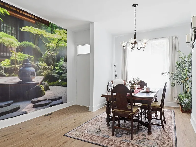 Dedicated dining area, full-size table, chandelier lighting, and large windows for natural light.