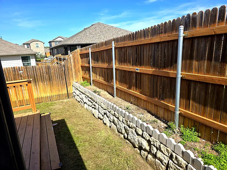 Raised garden bed adds charm and usable outdoor space.