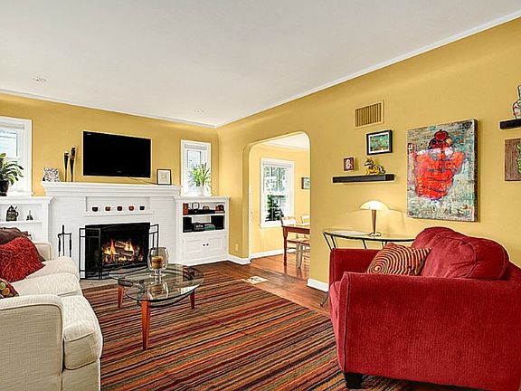 Living room mantled fireplace flanked by bookshelves.