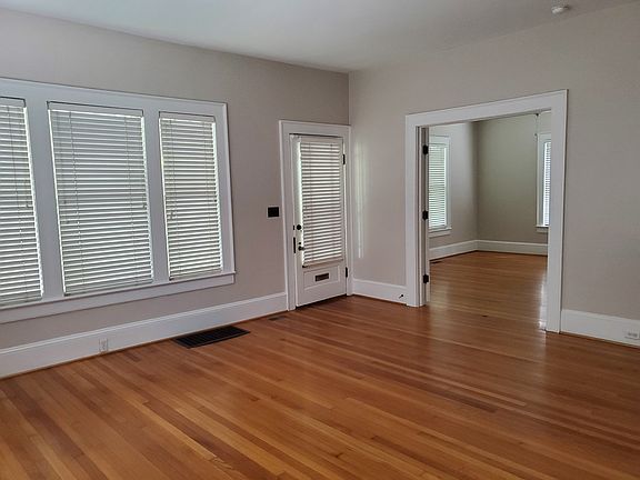 Living room looking at front door and French doors into den