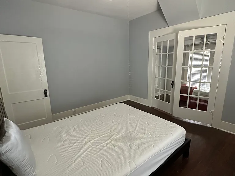 Bedroom (queen size bed not included in rental) with french door access to 1/2 bedroom / office
