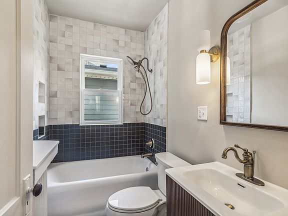 Beautifully tiled shower and updated plumbing fixtures!
