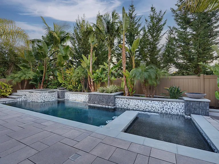 Black pebble bottom pool, spa and swim up bar