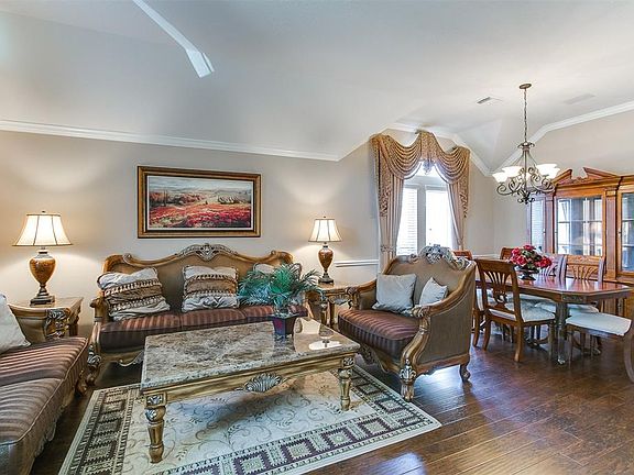 The living room is open to the formal dining room creating a great space that is perfect for hosting gatherings and entertaining.