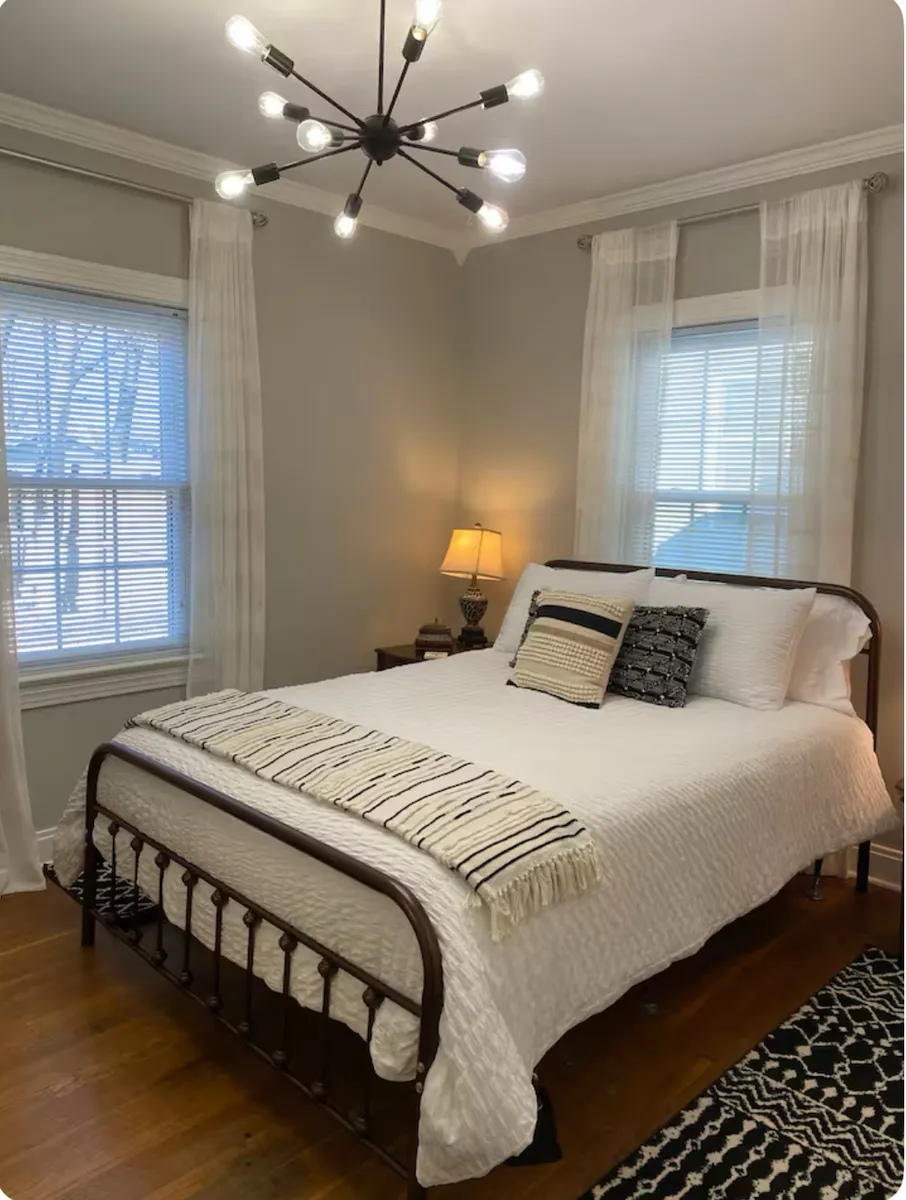 main floor guestroom with queen size bed, and dresser - 919 E Court Ave