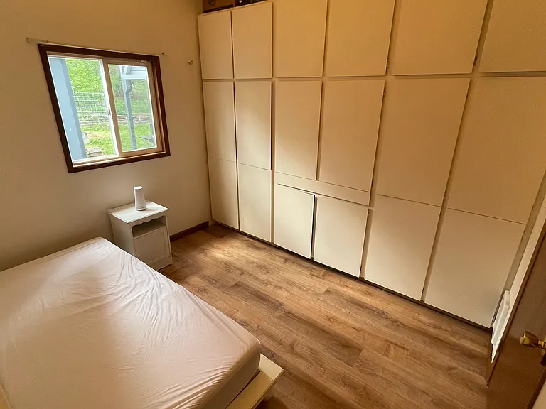 Bedroom #3 or possible office/craft room - full wall of deep cabinets for storage and small pull out desk