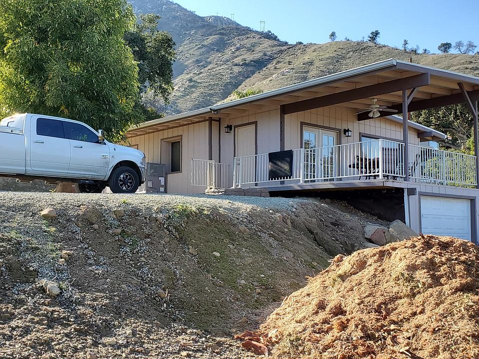 View from driveway, 20' x 20' x 7' carport being installed where truck is parked. (2 vehicles)