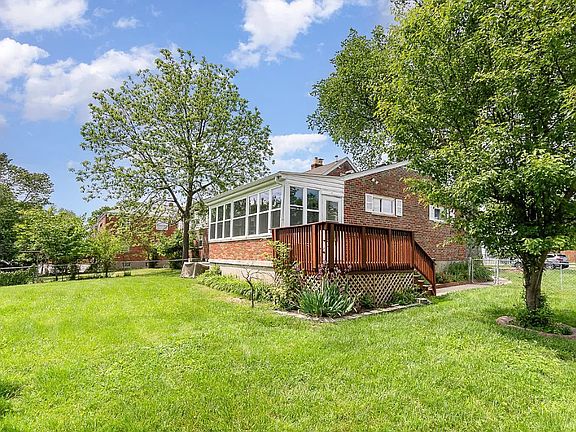 Large fenced backyard with deck & 3 season room!