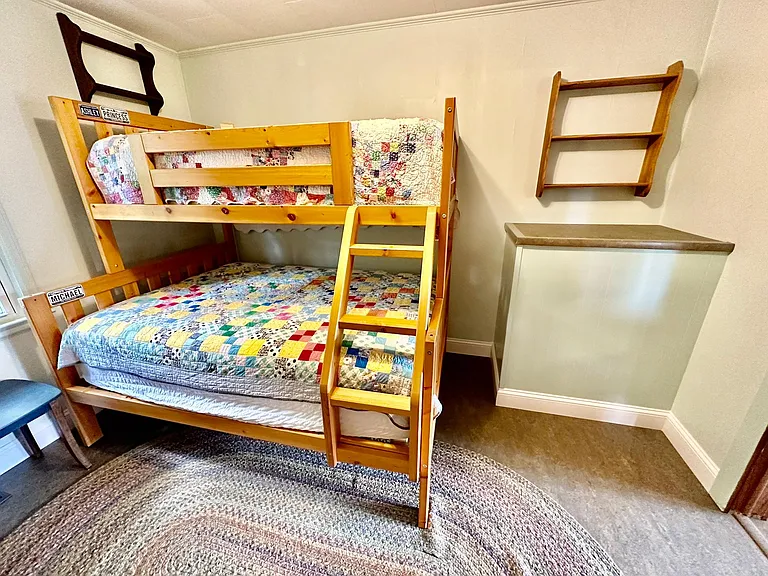 The bunk bed has a double bed topped by a single bed.