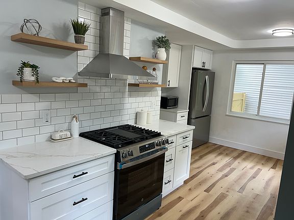 open shelving with plenty of cabinet storage 
stainless steel appliance