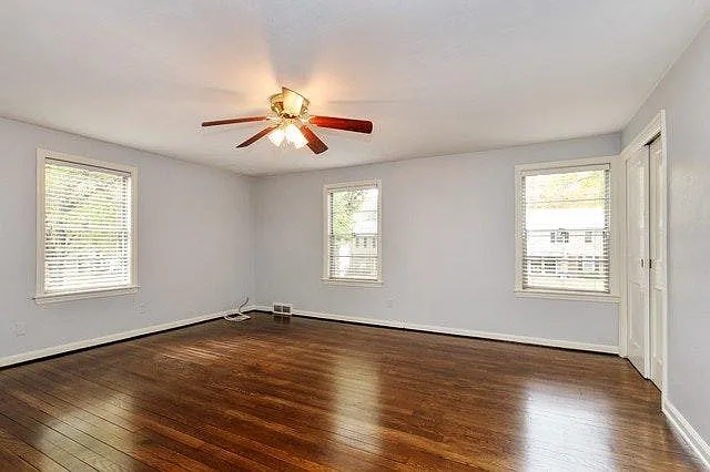 HUGE primary bedroom with hardwood floors and a large walk in closet.
