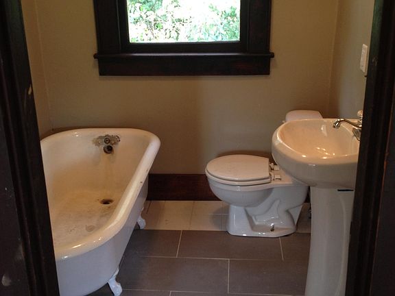 Tiled bathroom with original claw-foot tub