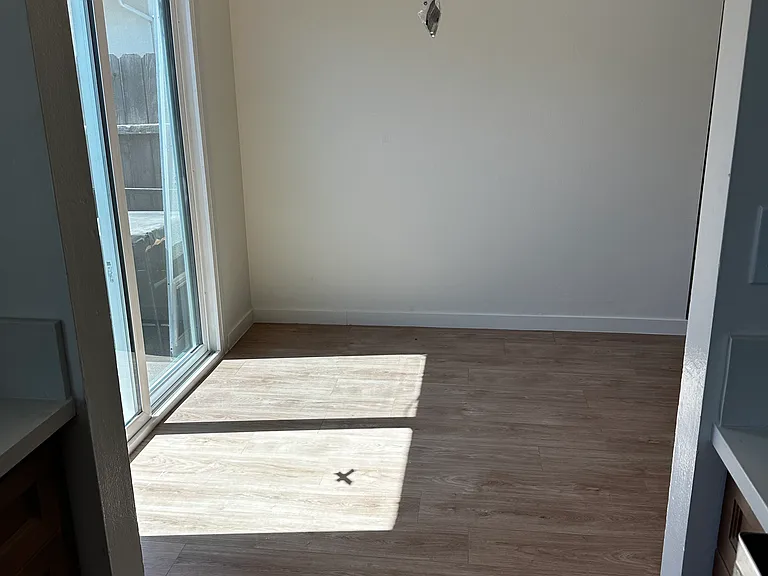Picture is from Kitchen looking into Dining Room and Small Patio Access. Installed Curtains not shown in this Photo
