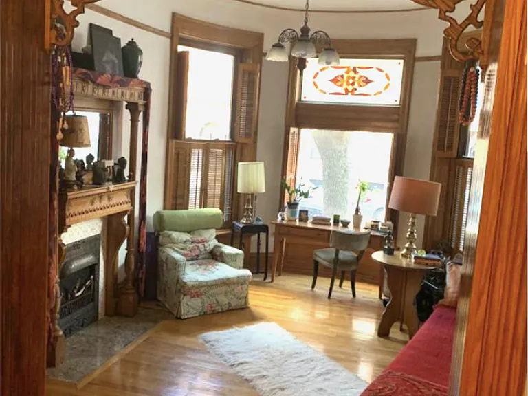 Spacious living room with vintage woodwork throughout.