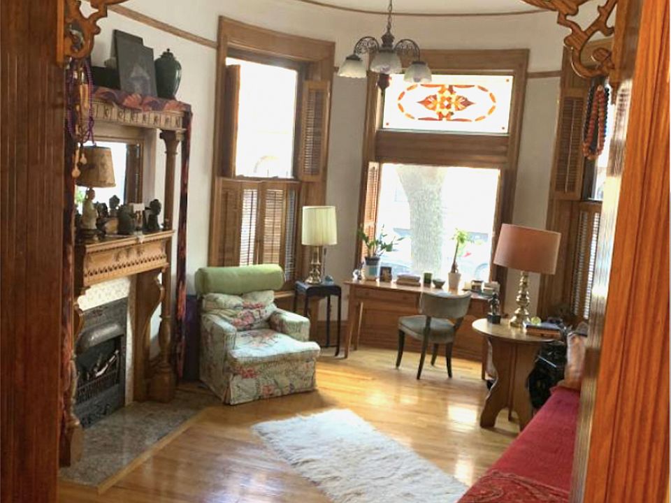 Spacious living room with vintage woodwork throughout.