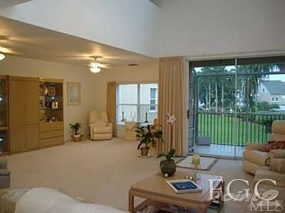 The oversized 2nd floor living room features sliders that open up to screened porch and beautiful vi