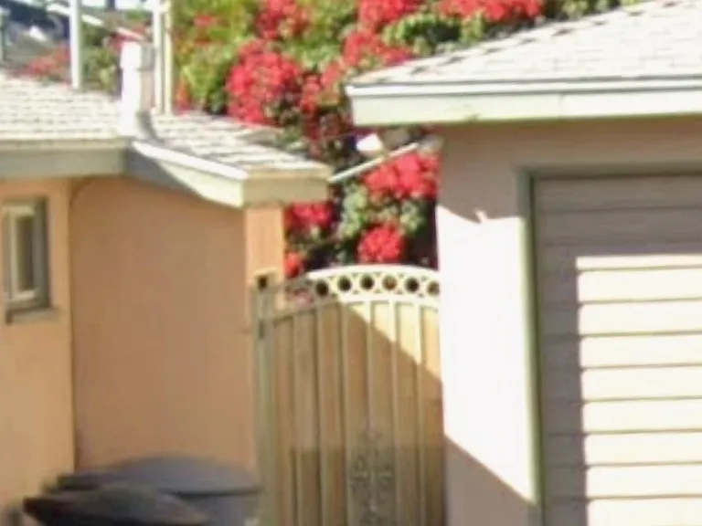 Private gate access to the garage and back door entrance into the kitchen