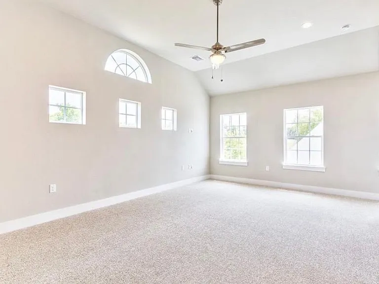 Primary bedroom is very spacious with loads of natural light and high ceilings!