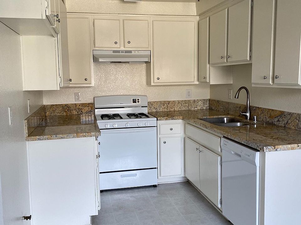 Kitchen with granite counter tops and gas stove and dishwasher