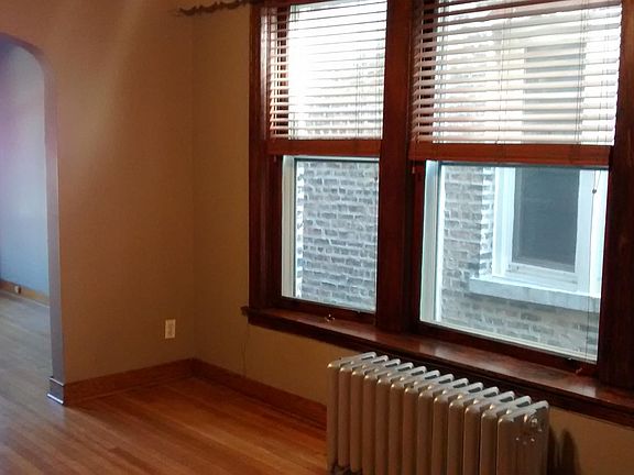 Dining room with wood blinds & bay windows