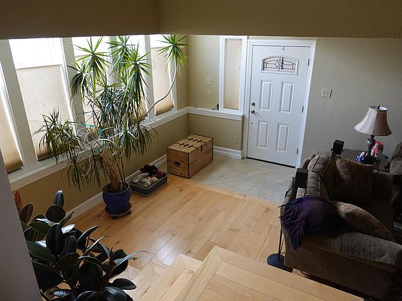 The view from the top of the lower flight of stairs looking at the front door. The kitchen is on the left in this pic, and the stairs to the third level are on the right.