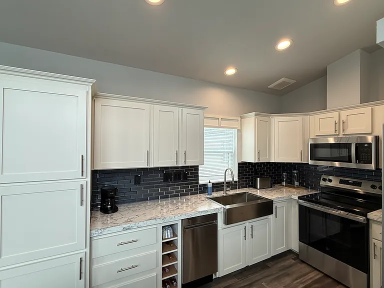 kitchen with large pantry, dishwasher, and wine rack