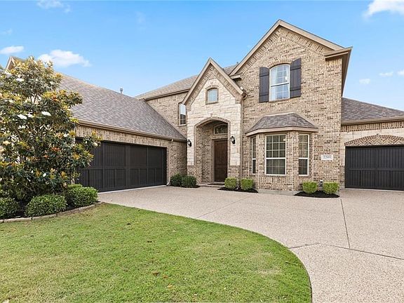 FRESHLY STAINED CEDAR GARAGE DOORS AND LUSH LANDSCAPING ADD TO THE CURB APPEAL OF THIS HOME!
