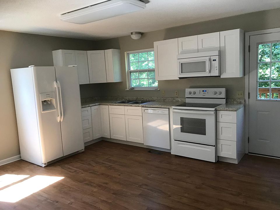 Kitchen on main level. Back door leads to one of the decks