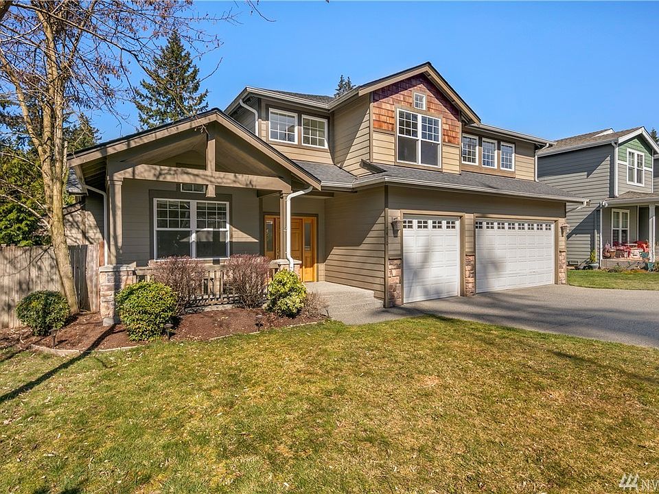 Elegant Craftsman style with 3 car wide garage and covered front porch welcomes you home. Located on a quiet private lane