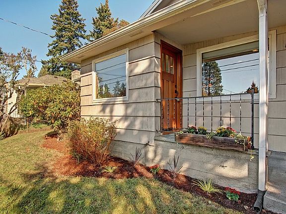 Front porch with window box welcomes you home! Enter through the custom, wood door.