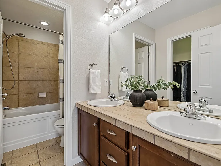 Master bath with double vanity and full size tub.