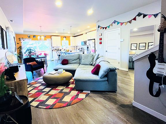 Open floor plan living space on main level with kitchen off to the right