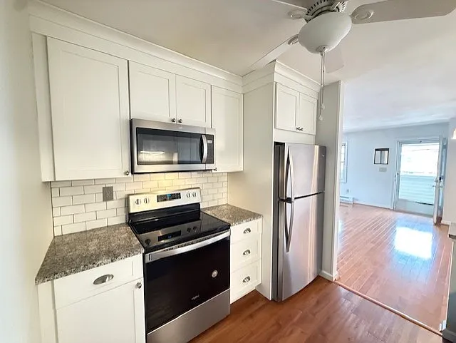 Newer kitchen with S.S. appliances, grante counter tops and subway tile backsplash