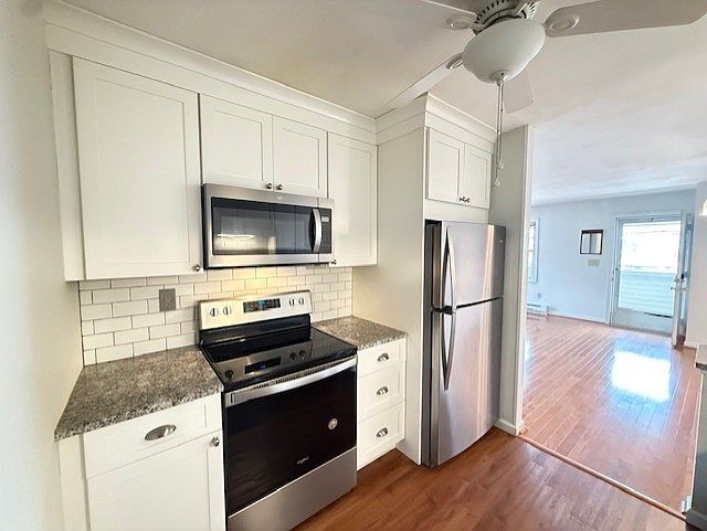 Newer kitchen with S.S. appliances, grante counter tops and subway tile backsplash