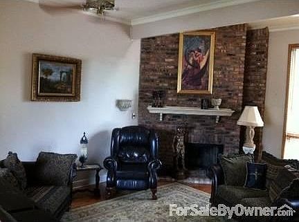 Living Area, wood burning fire place : Large windows over looking the deck and private lake, wood fl