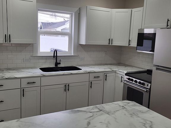 Updated kitchen with new fridge, stove and microwave.