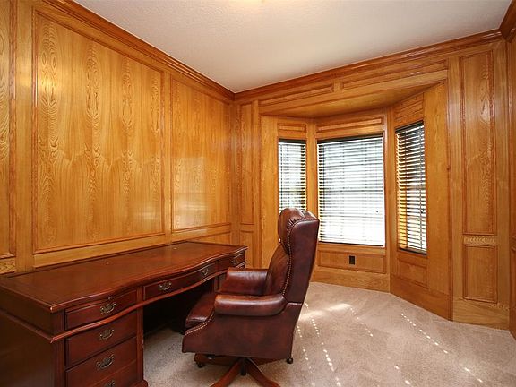 To the right of the entry is the wood-paneled study. The spacious room has a bay window facing the front of the home.