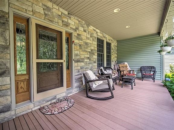 Relax and enjoy the covered front porch looking out at the professionally landscaped yard!