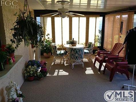 Lanai or back porch looking at partial lake view
