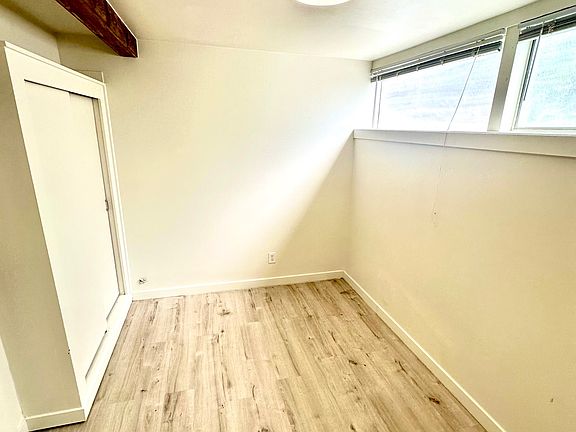 Good light, architectural beam, hardwood floors and modern light fixtures create a cozy bedroom