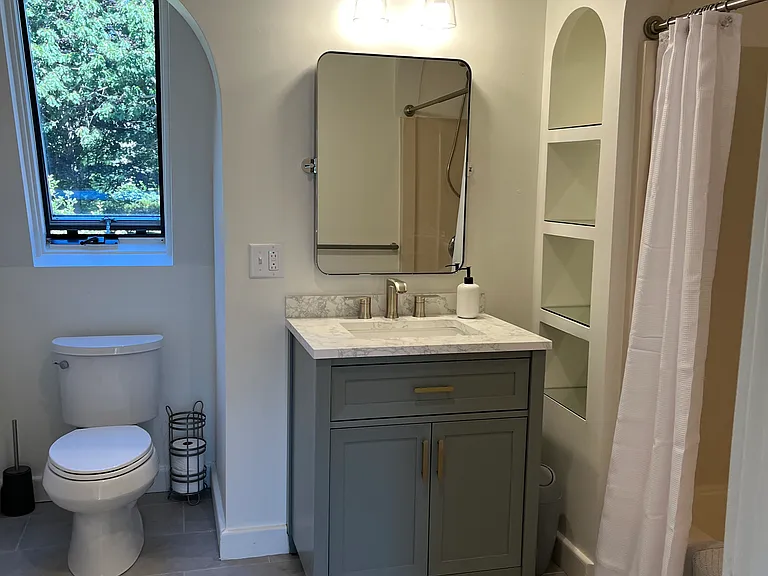 Newly updated full bathroom includes new porcelain ceramic tile, all new fixures; new vanity sink, toilet, mirror and lights.